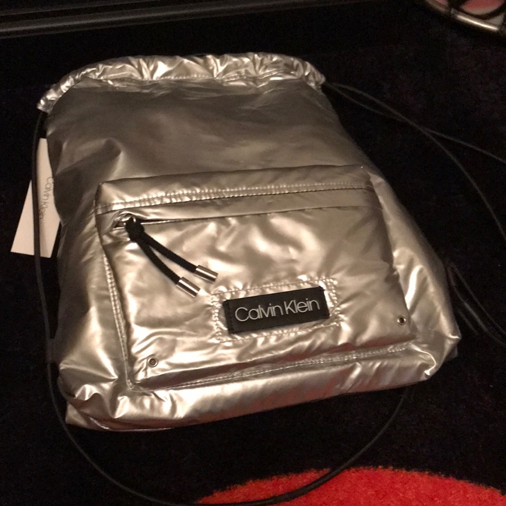 Calvin Klein silver purse backpack style